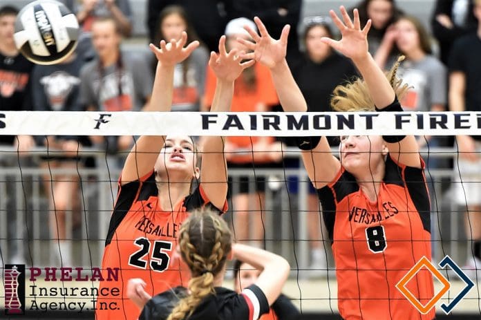 Taylor Wagner (25) and Kirsten Bomholt (8) team up for a Versailles block in the Lady Tigers win over Cardington-Lincoln. (Gaylen Blosser photo)
